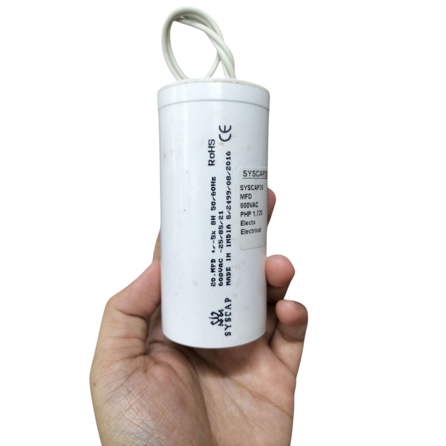 Syscap 20MFD motor running capacitor 600V in a hand, ideal for electrical applications