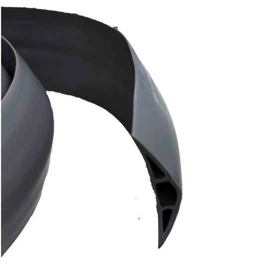 A close-up of a dark gray or black curved hollow-profile strip or trim piece on a plain white background.