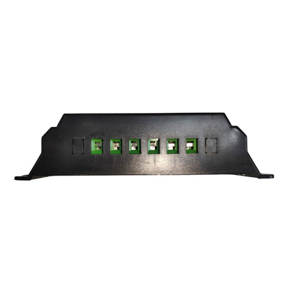 A black metal electronic junction box cover with six green terminal blocks on a plain white background.