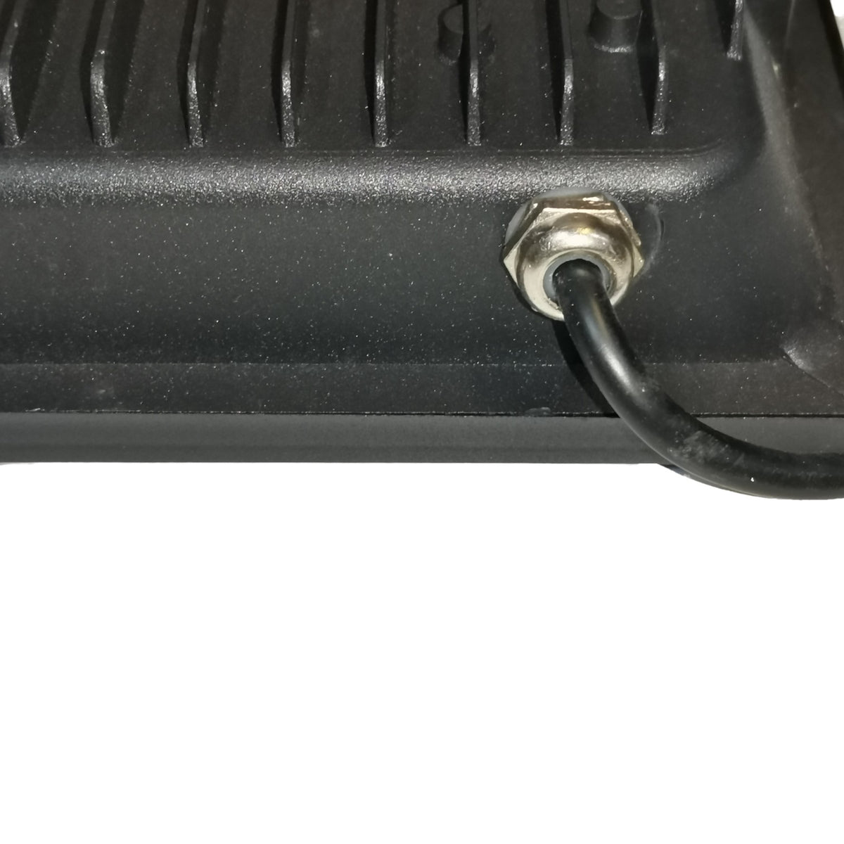 Close-up of a black metal component with a wire connection on a white background