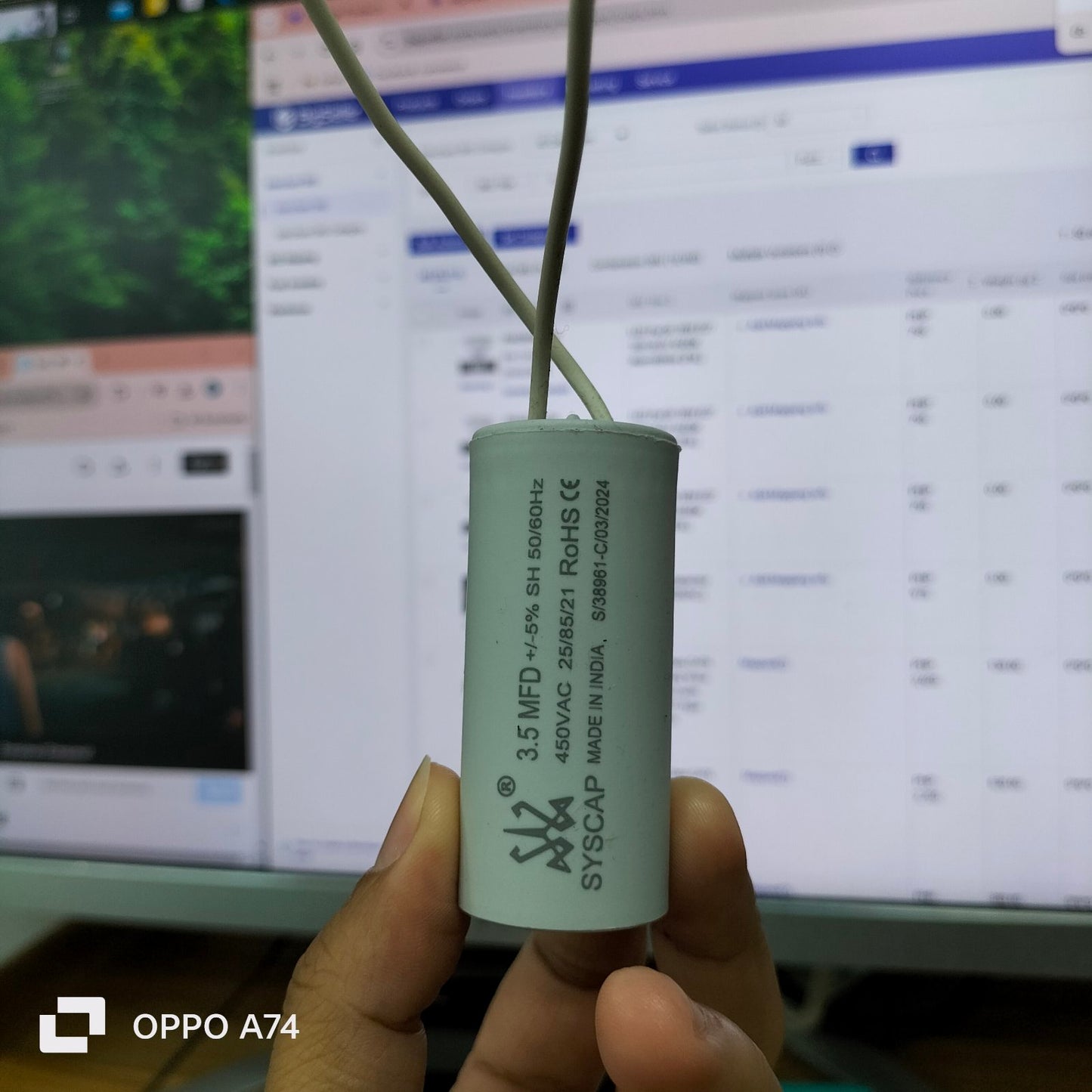 Syscap 450V AC Running Capacitor in a white cylindrical design with electrical ratings