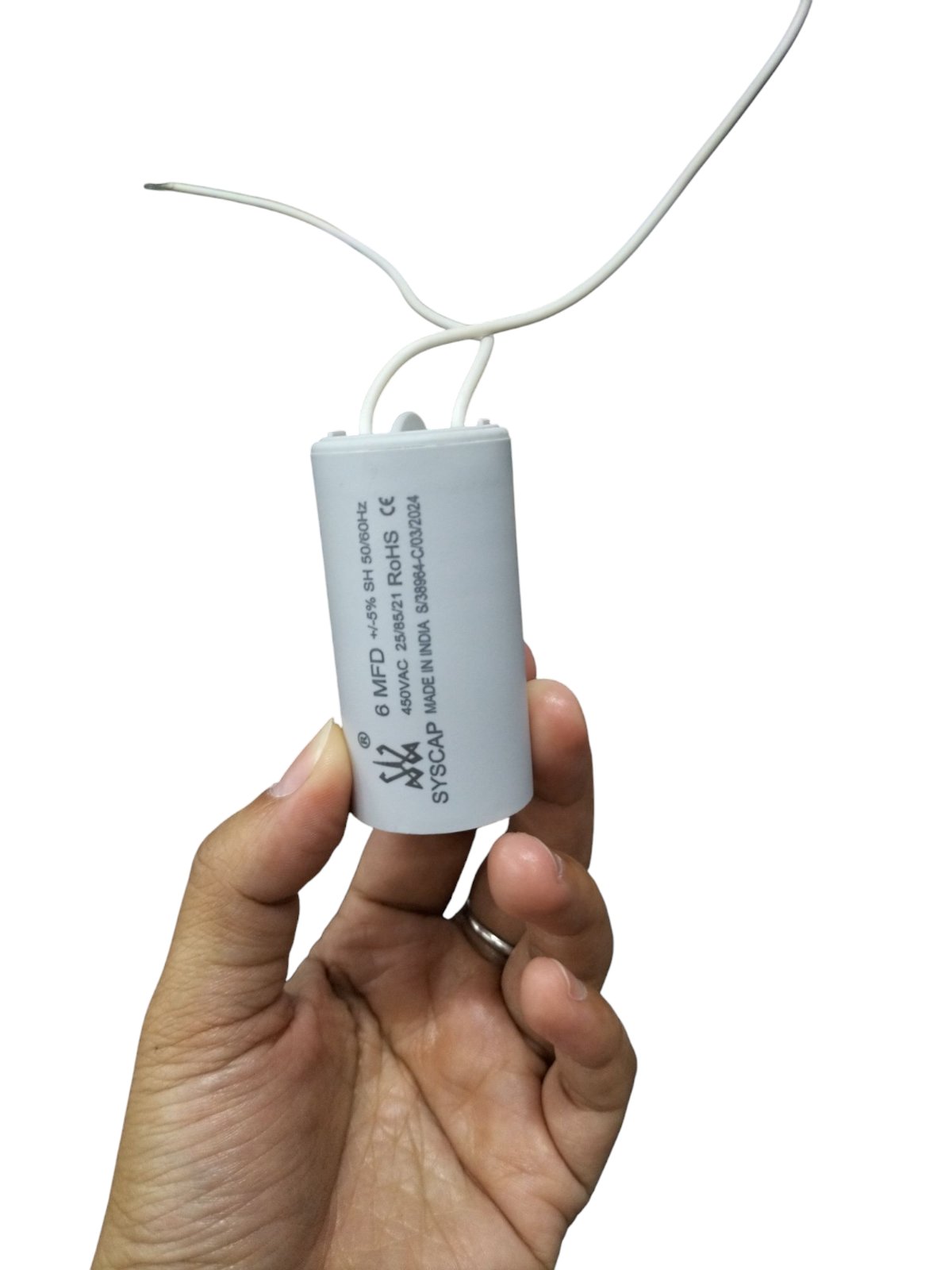 6MFD Motor Running Capacitor by Syscap held in a hand for electrical circuit applications