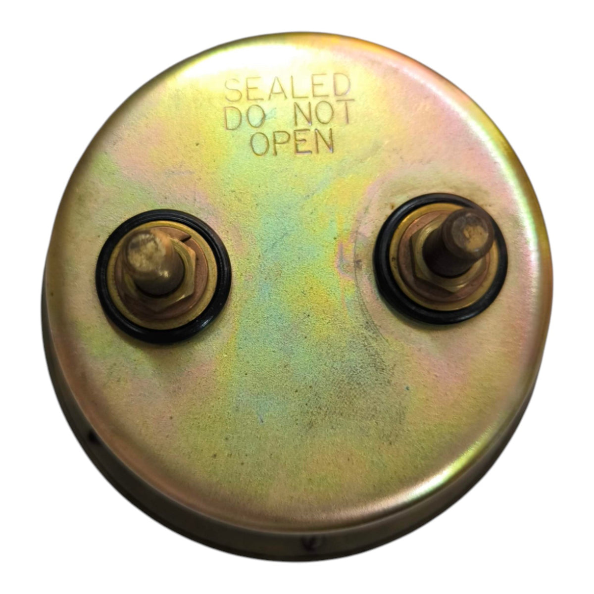 A round metal automotive cap or filter component with two threaded ports and black rubber seals, featuring the stamped text 'SEALED DO NOT OPEN' on a white background.