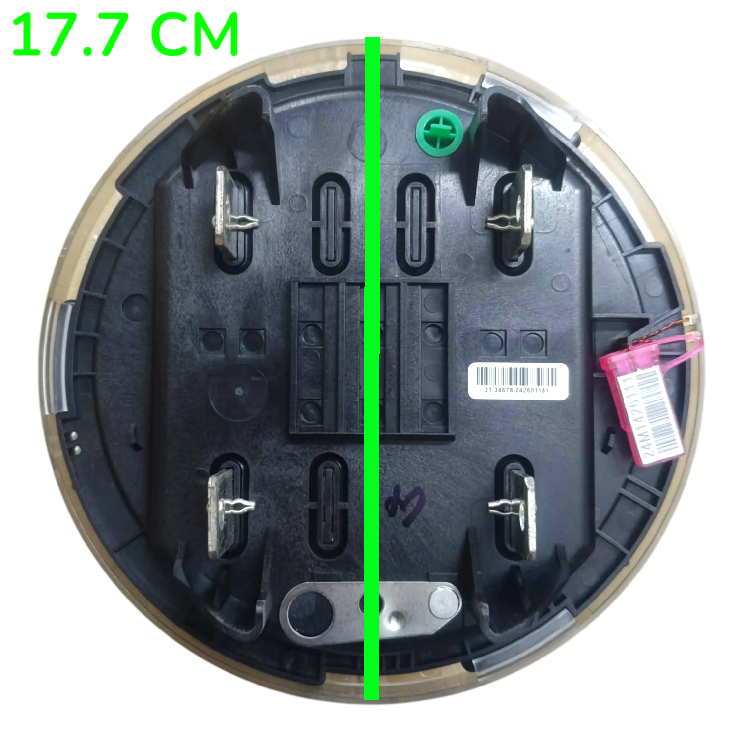 Top-down view of a circular black plastic product base or tray with metal terminals, a barcode sticker, and a pink tag, shown on a white background with a green vertical measurement line and the text '17.7 CM' in the top left.