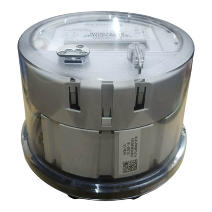 A cylindrical electrical meter with a clear plastic top cover and a gray plastic body, shown on a plain white background.