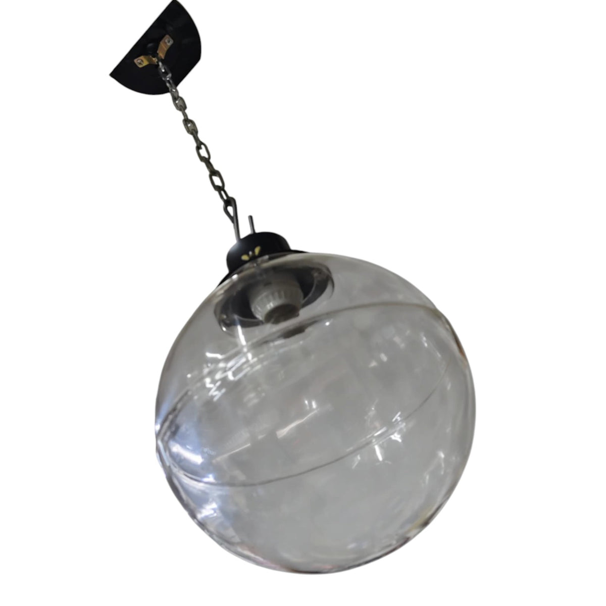 A large clear glass globe pendant light hanging from a black ceiling canopy and chain against a plain white background.
