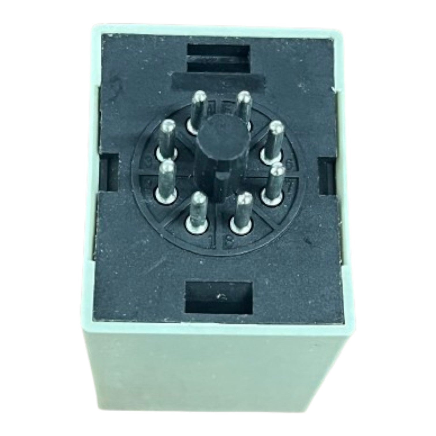 Black electronic component with metallic pins on a white background