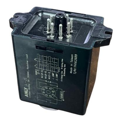 Black relay with terminal pins on a white background