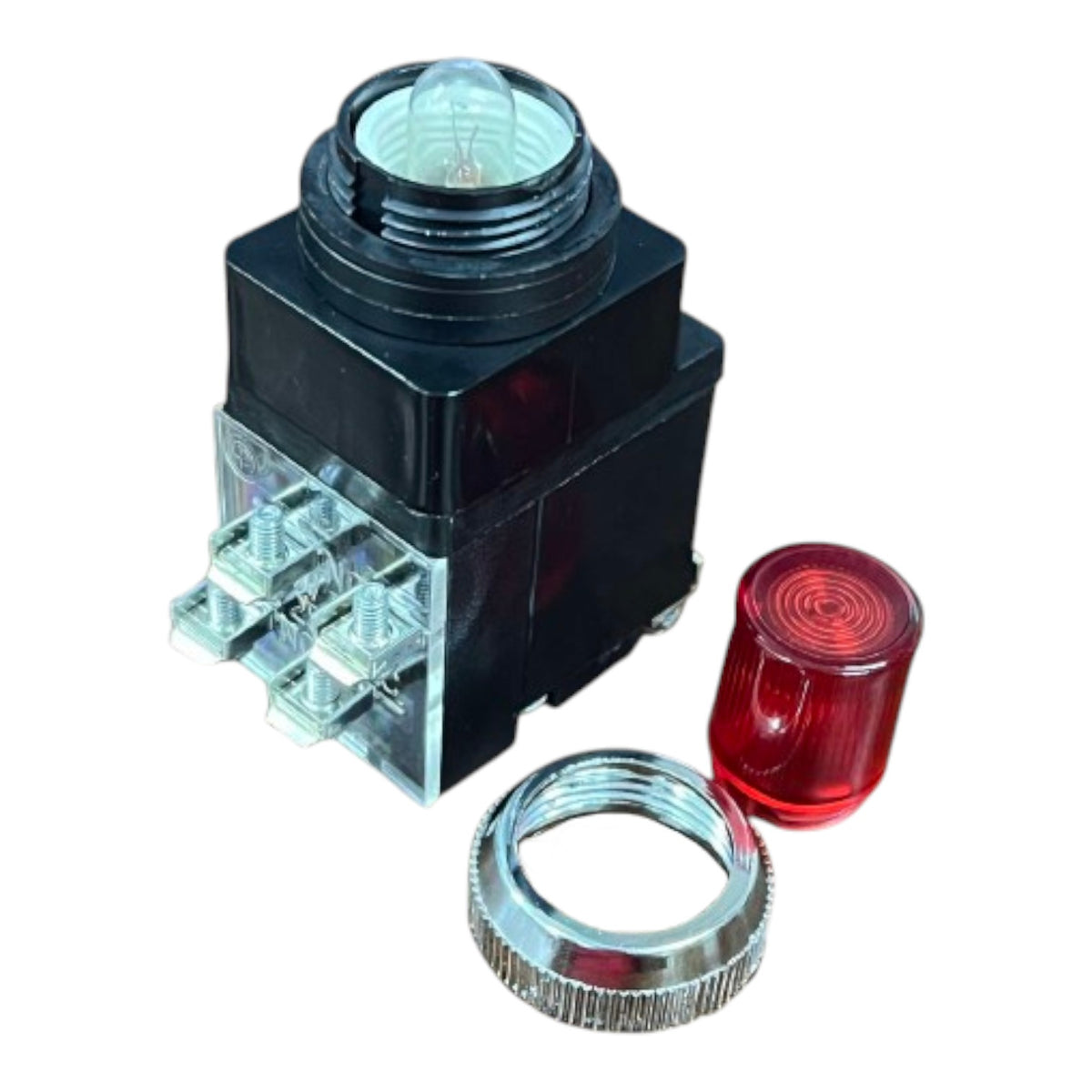 A black electrical push-button switch module with a clear glass lens on top, a transparent terminal cover, and a separate red lens cover cap, shown on a white background.