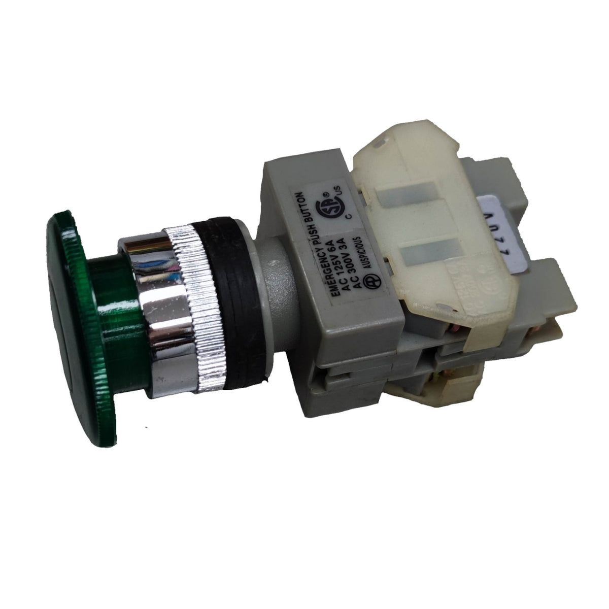 A industrial push-button switch module with a green button face, silver and black metallic collar, gray plastic housing, and a cream-colored plastic cover on the terminal side.