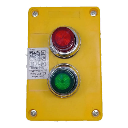 A yellow industrial control panel featuring two large push buttons: a red emergency stop button on top and a green start button on the bottom, both with silver metal bezels. The panel is secured with four corner screws and has a white QR code sticker on the left side.