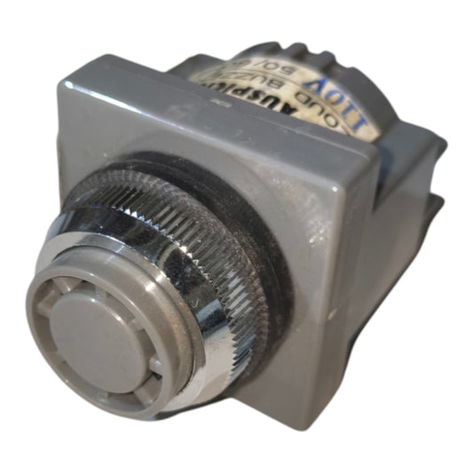 A vintage automotive or industrial switch module with a gray plastic housing, a silver metal knob, and a white label showing technical specifications.