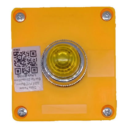 A square orange-yellow plastic button panel with four corner screws and a central round yellow push-button with a silver metal bezel. A white QR code label is attached on the left side.