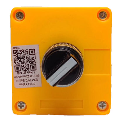 A square yellow plastic push button box cover with four corner screws, a central circular opening, and a white product label with a QR code.