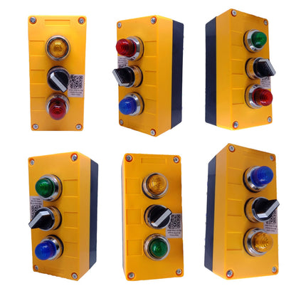 Six yellow industrial control push-button panels arranged in a 2x3 grid on a white background. Each panel has different button configurations including red, blue, green, and amber lights with black, white, and silver switches.