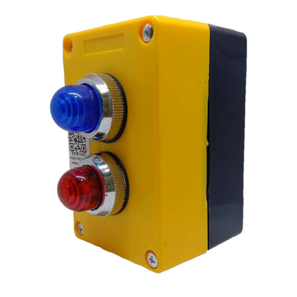 A yellow industrial electrical control box with two push buttons, a blue indicator light on top and a red main button below, set against a plain white background.