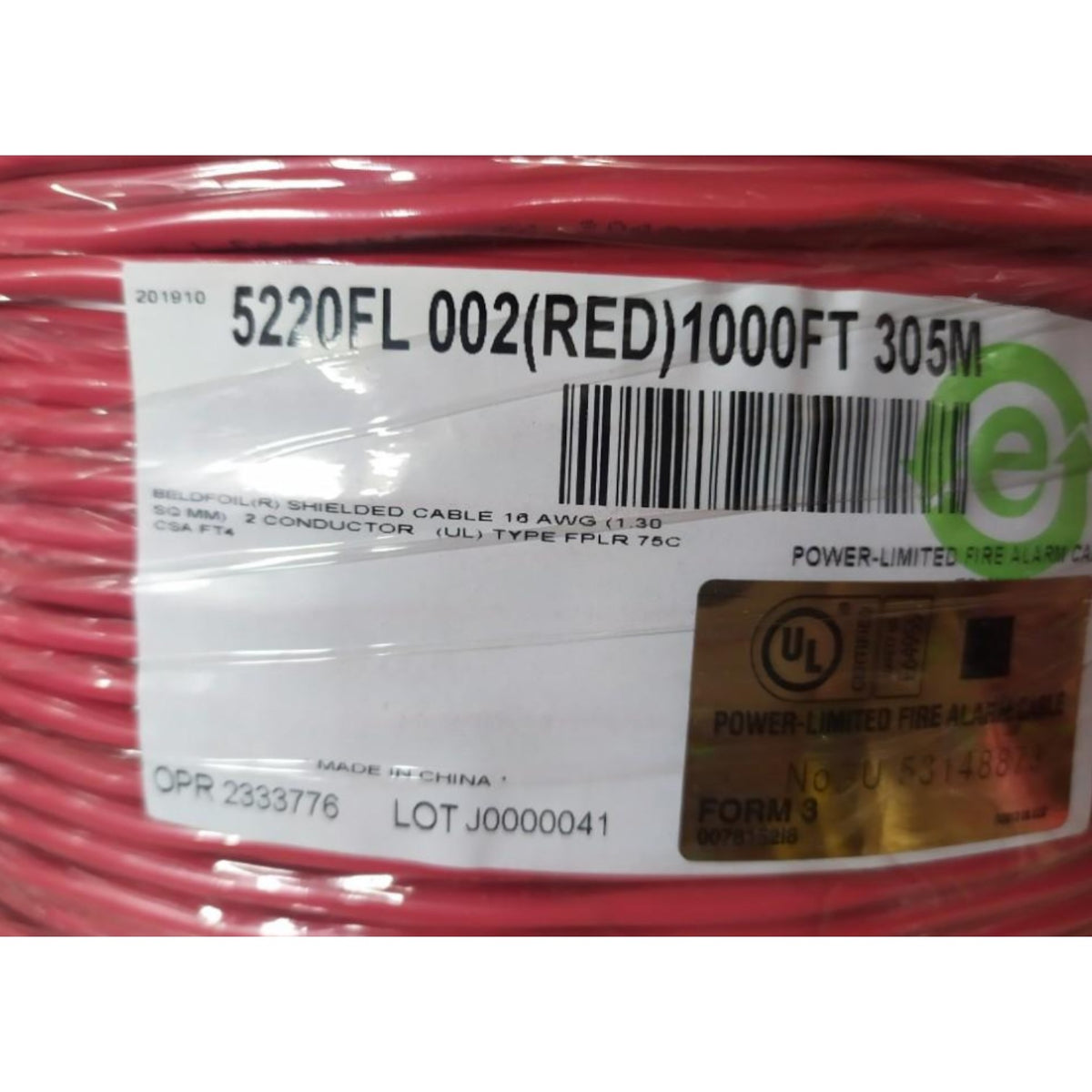 A close-up of a red fire alarm cable wound on a spool, wrapped in clear plastic with a white product label showing barcode and UL certification details.