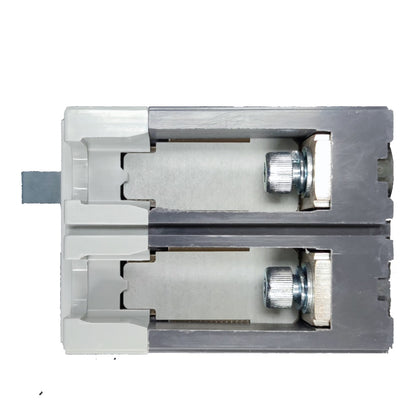 A close-up of a metal lock cylinder or door lock mechanism shown in a cutaway view, with silver-toned metal components, a gray outer frame, and a small blue tab on the left side, photographed on a plain white background.