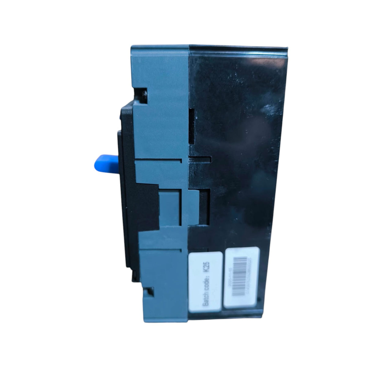 A dark gray plastic electrical component or switch module with a small blue protruding tab and two white labels on the side, shown against a plain white background.