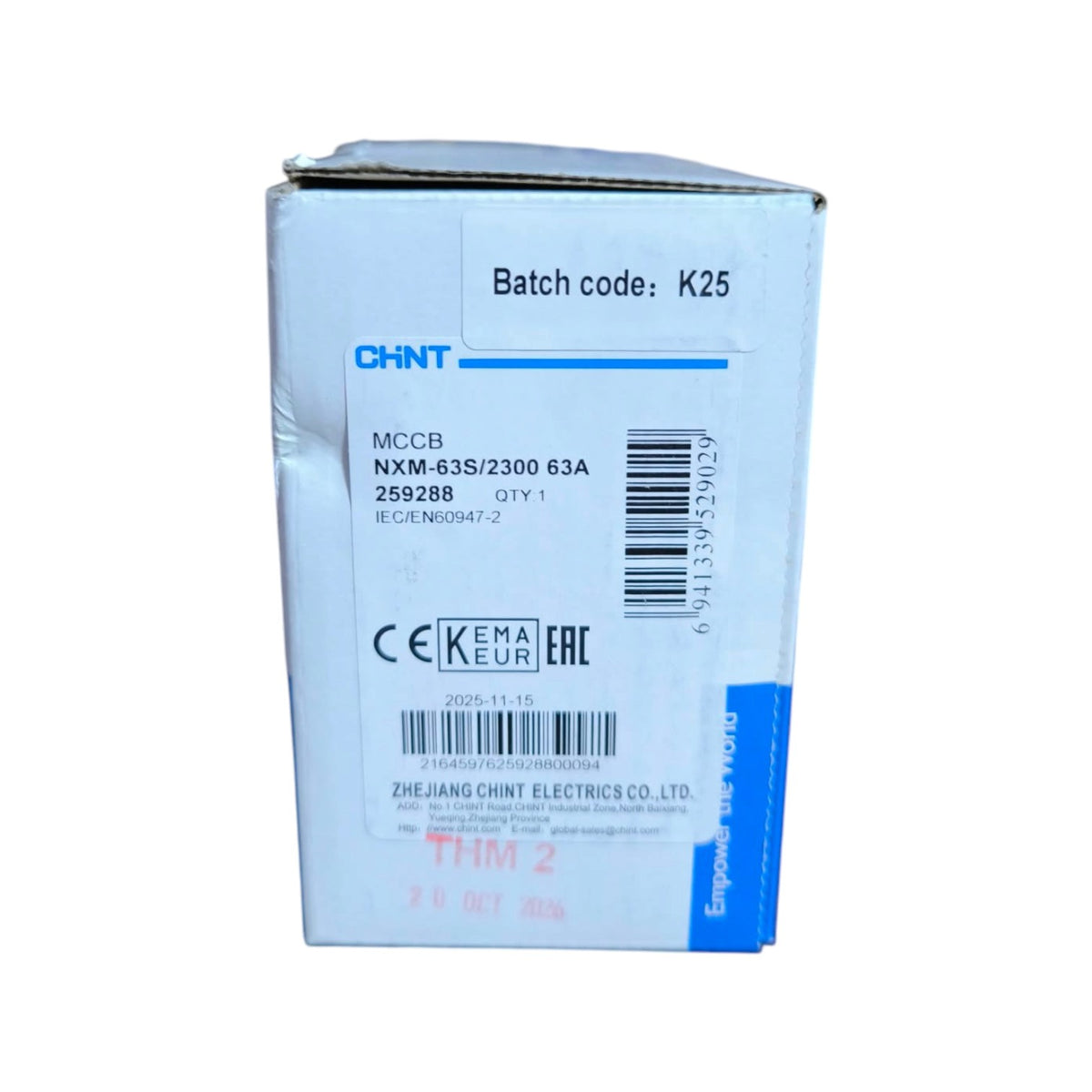 A white cardboard box for a CHNT MCCB NXM-63S/2300 63A electrical component, featuring blue text and barcodes on a white background.