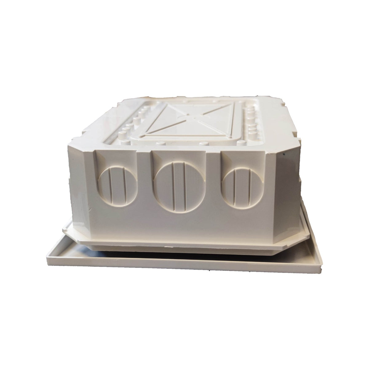 A white molded plastic electrical junction box cover with three circular entry slots on the front, resting on a matching flat base against a plain white background.