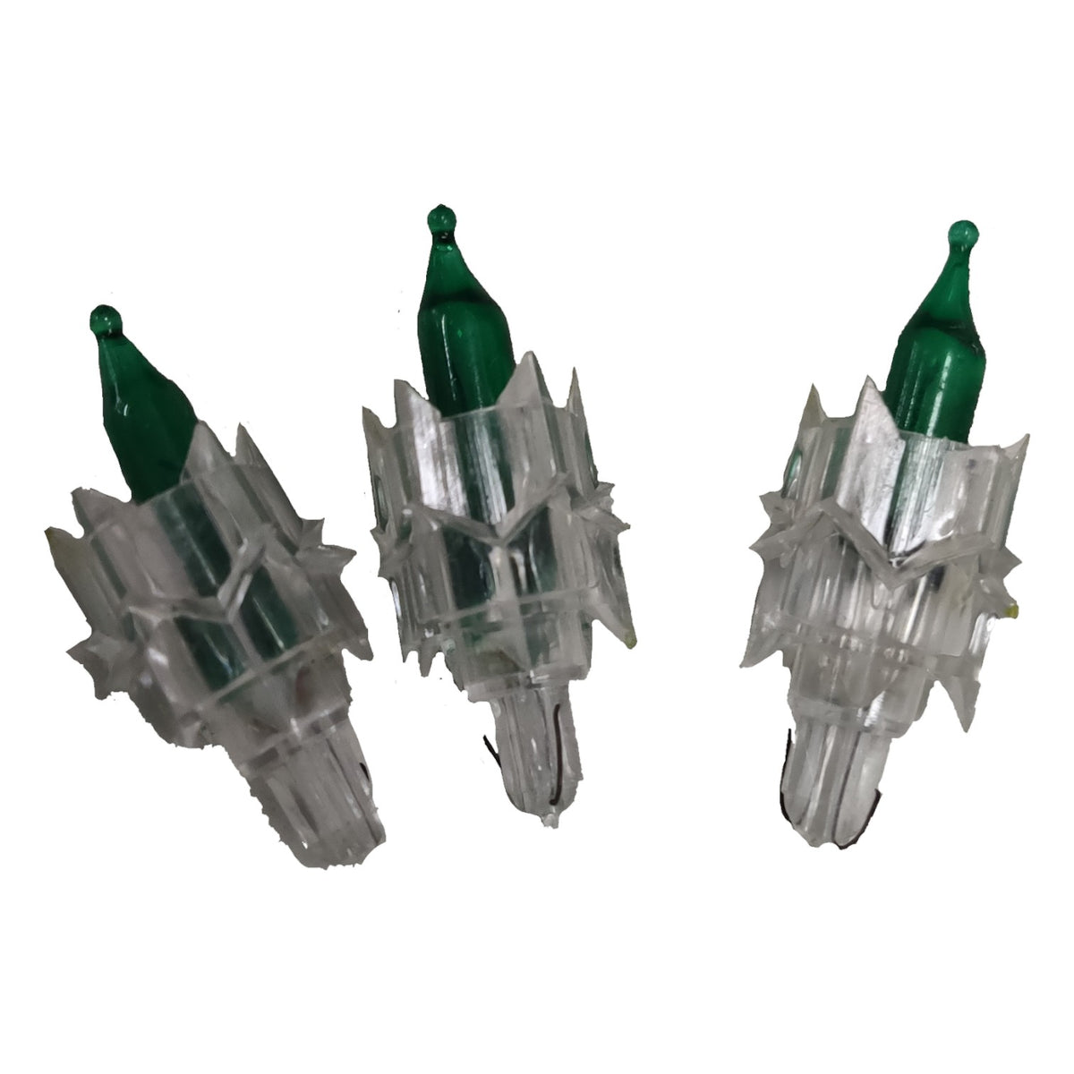Three clear plastic Christmas tree lights with green bulbs on a white background