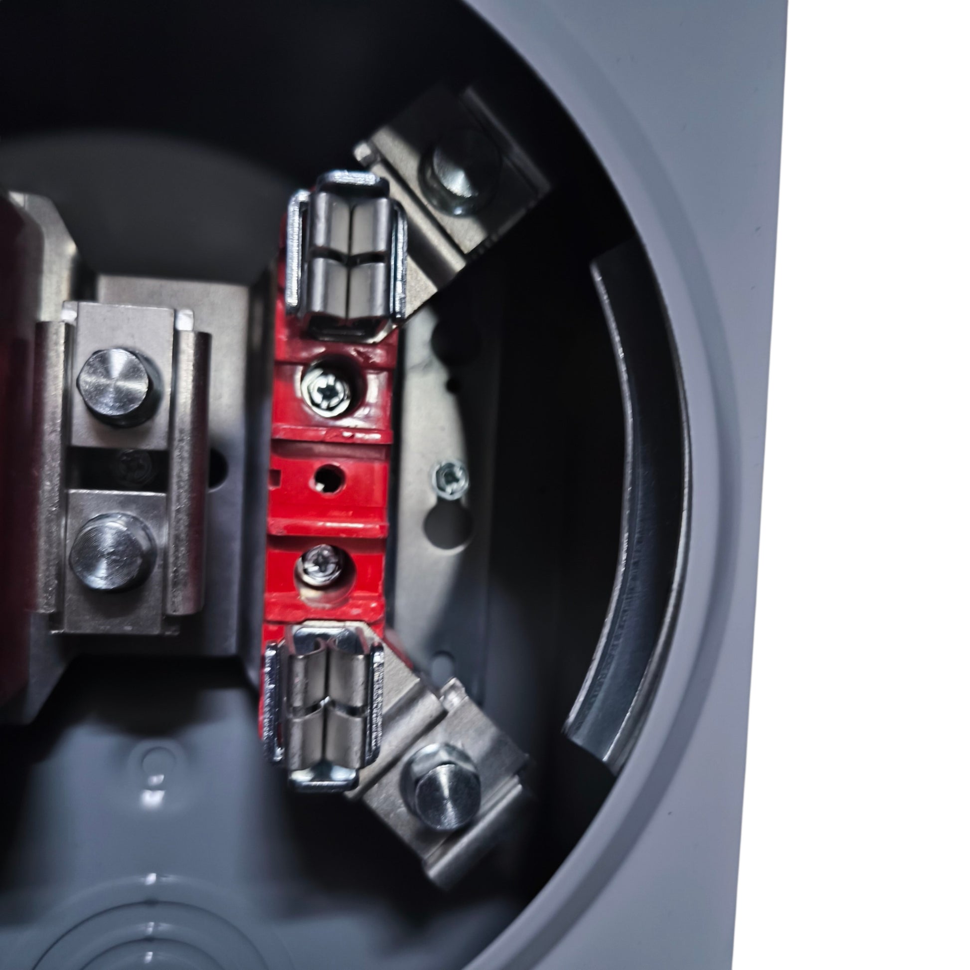 Close-up of a mechanical component with red and silver parts on a dark background