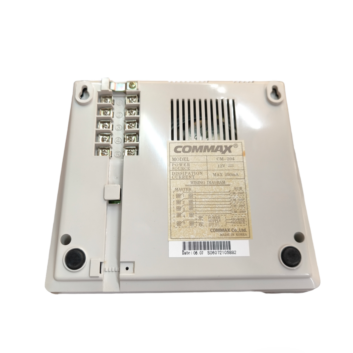Back view of Commax 4 station intercom system showing connection terminals and label
