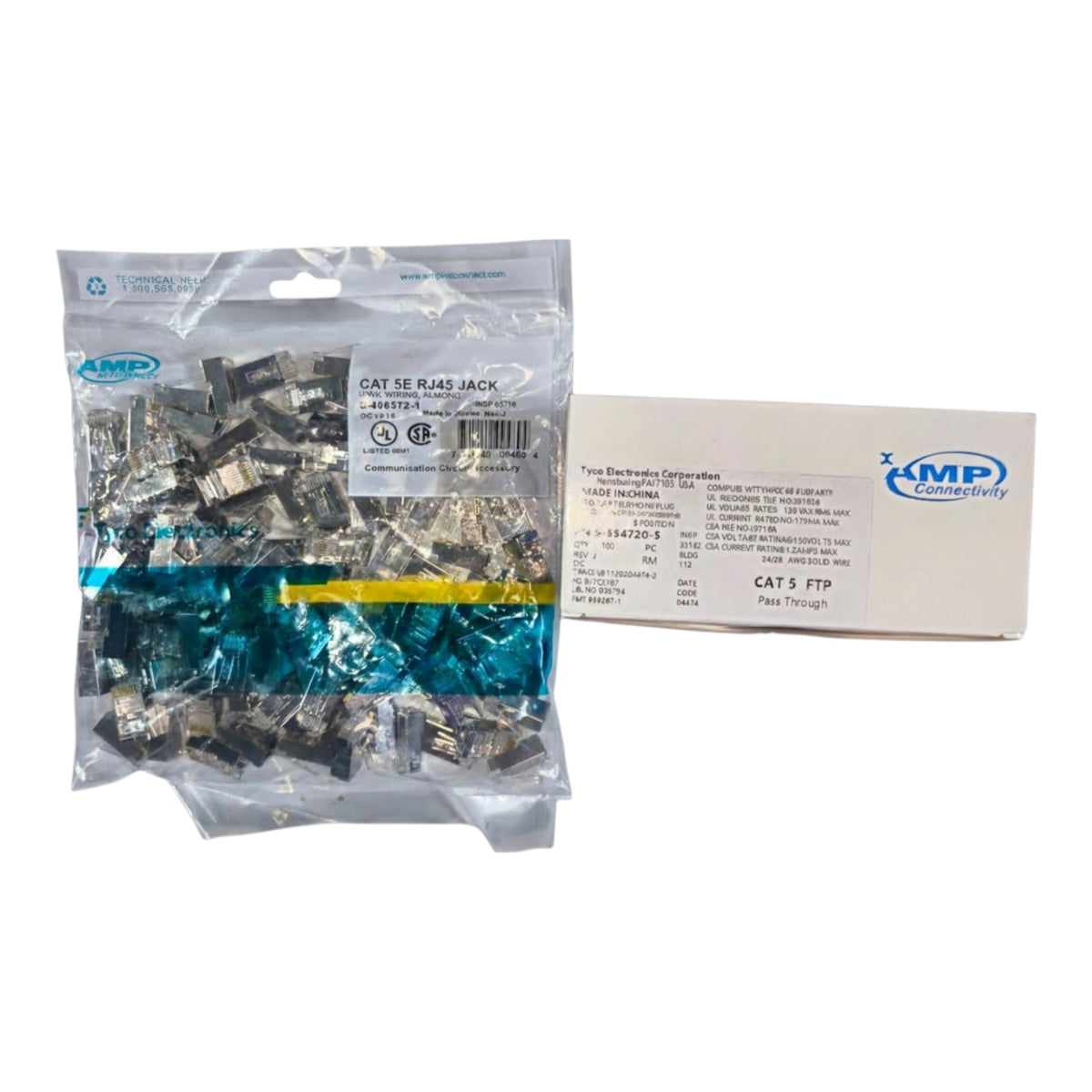 A clear plastic bag filled with small silver metal electronic components next to a white cardboard box, both branded AMP, on a plain white background.