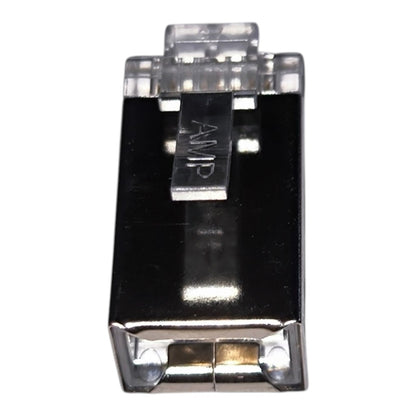 A single electronic component, likely a small amplifier module or connector, featuring a glossy black body, silver metal contacts, and a clear plastic top cover with the letters 'AMP' printed on it, set against a plain white background.