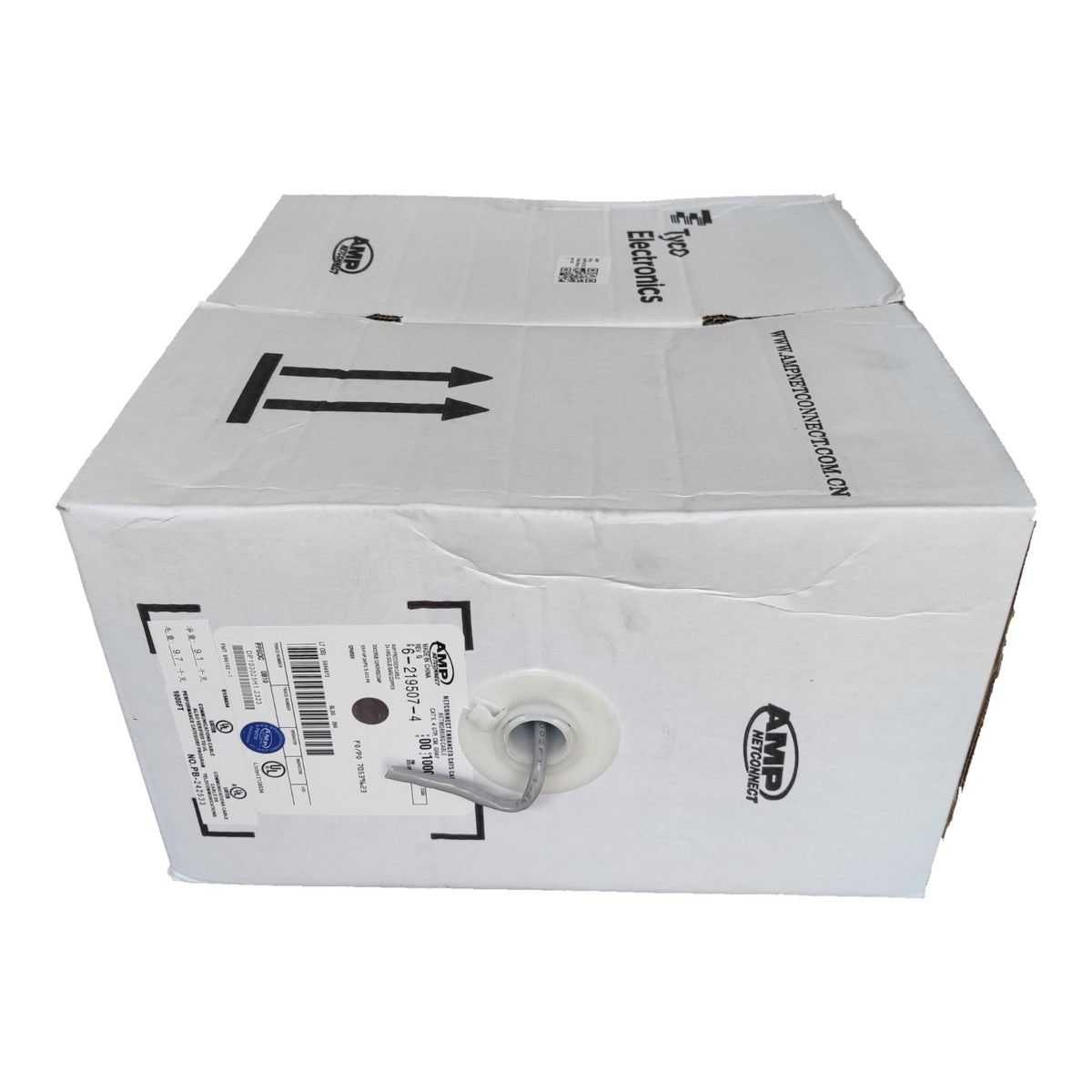 A white cardboard shipping box with printed black arrows, a barcode label, and AMP branding, photographed on a plain white background.
