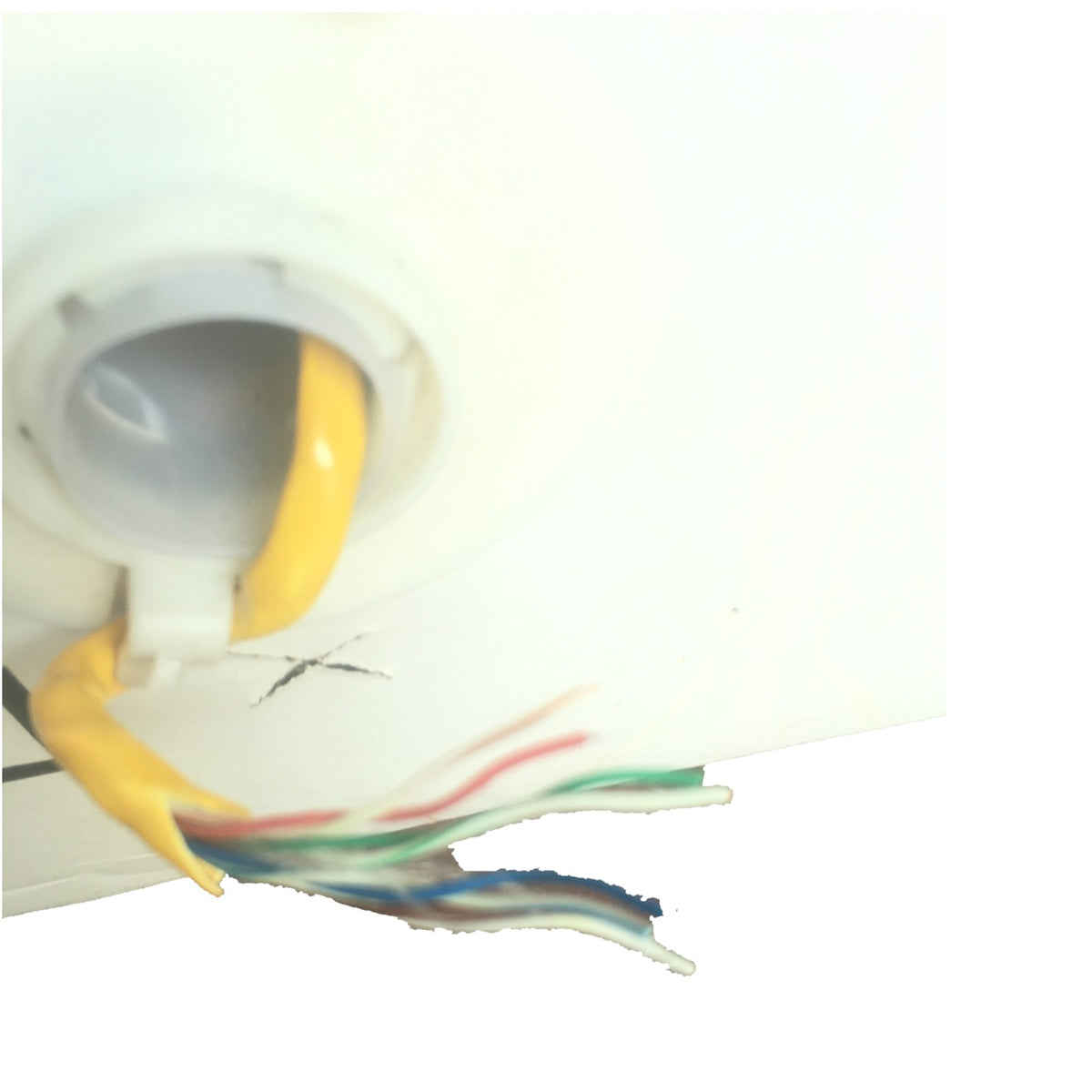 A close-up of a white ceiling light fixture showing the back of the bulb socket with a yellow cord entering from the top and several multicolored wires exposed below.