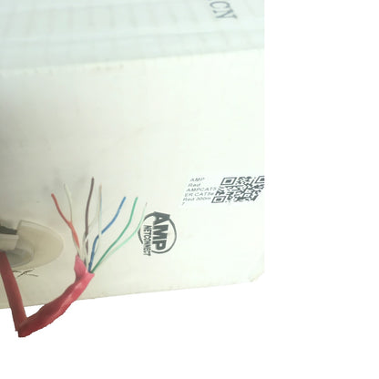Close-up of a white electronic device showing a multi-colored cable connector with exposed wires and printed specifications.