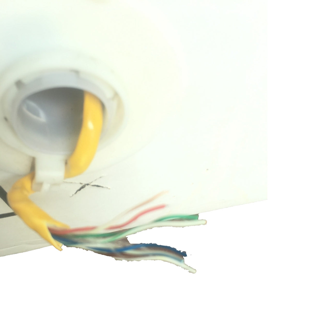 Close-up of a white ceiling light fixture showing a yellow cord entering the socket and several multicolored wires extending out against a white background.