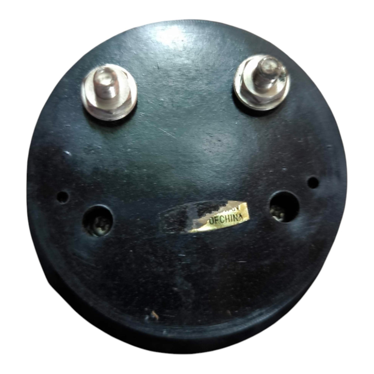 A round black circular component with two silver metal posts on top and a small yellow label reading 'DECHURA' near the center, shown on a plain white background.
