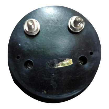 A round black circular component with two silver metal posts on top and a small yellow label reading 'DECHURA' near the center, shown on a plain white background.