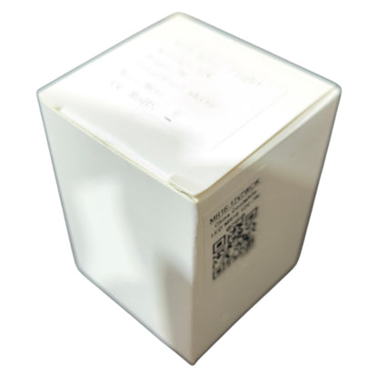 White cube-shaped object with a QR code on a white background