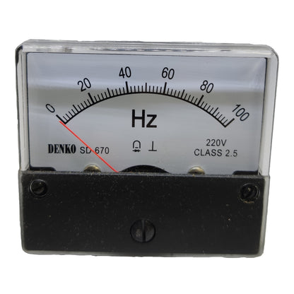 A Denko SD-670 analog frequency meter with a black housing, clear protective glass cover, and a white dial face showing Hz markings from 0 to 100.