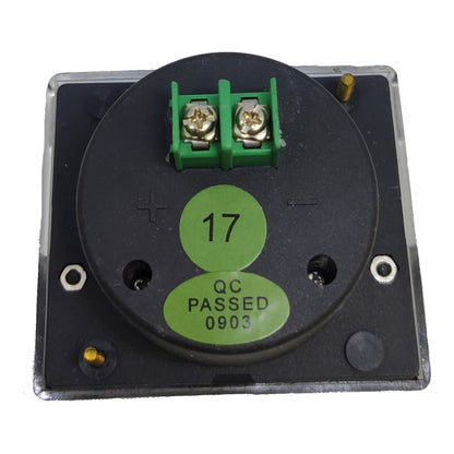 A square electronic component with a black circular face, green terminal blocks, and a green sticker reading '17 QC PASSED 0903' on a white background.