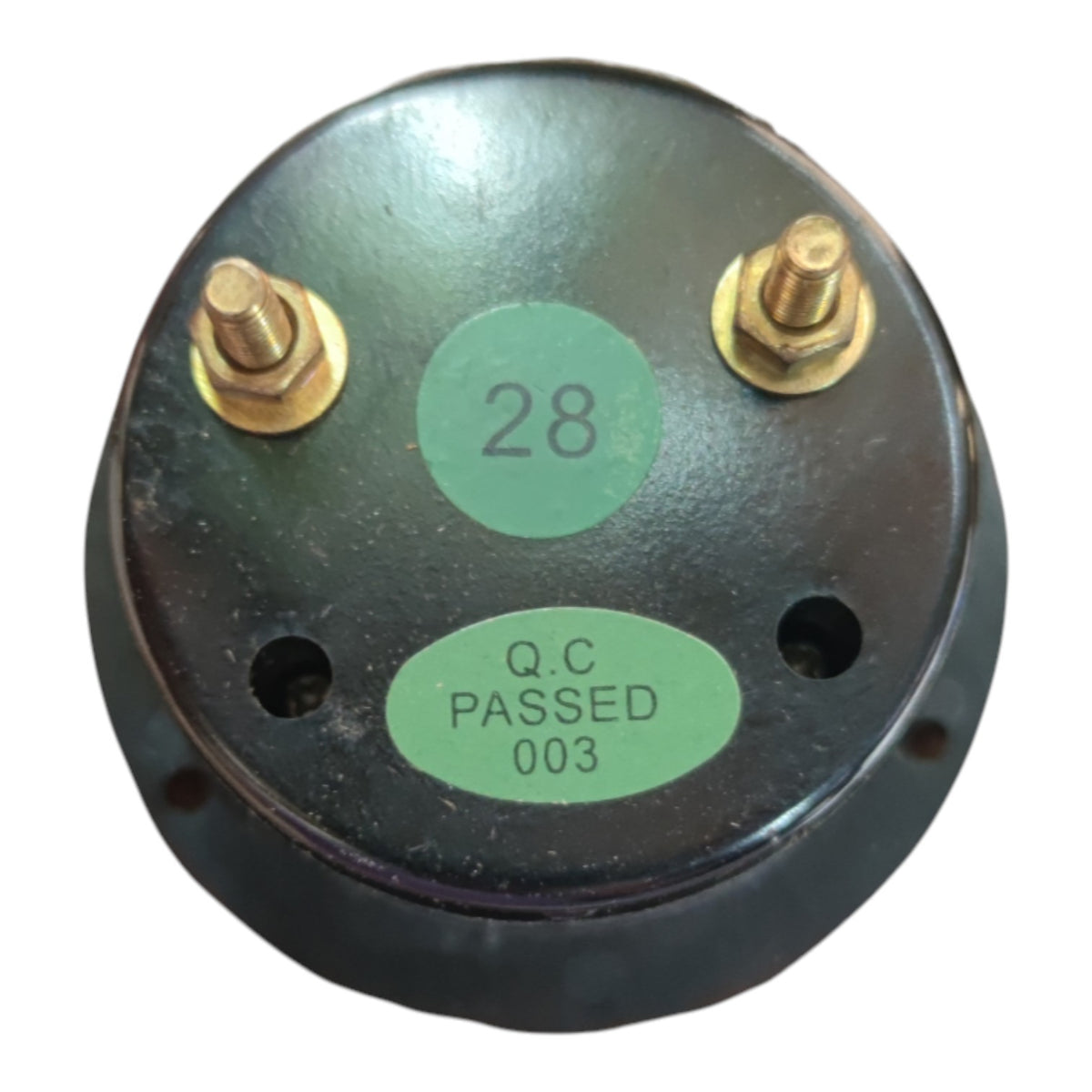 A round black metal electrical component with two brass screw terminals and two green circular stickers, one reading '28' and the other 'Q.C PASSED 003', on a white background.
