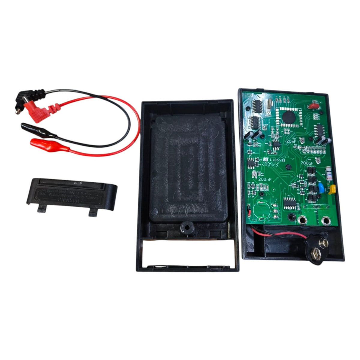Electronic components including a circuit board, battery pack, and connectors on a white background