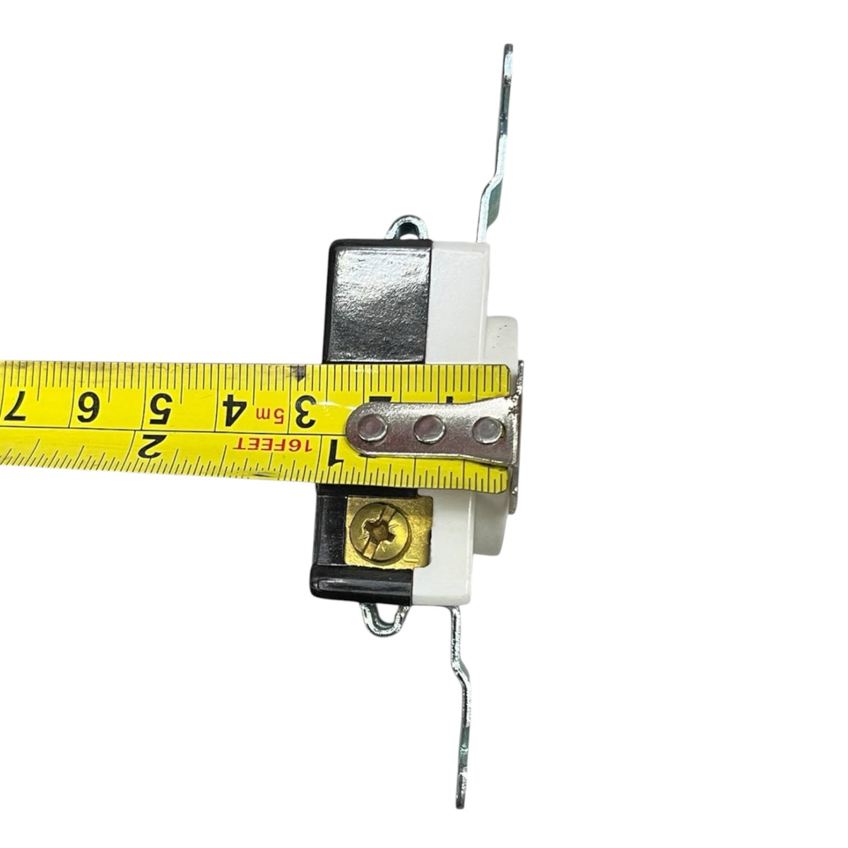 A white electrical outlet with black and brass components, shown with a yellow tape measure spanning across it to indicate dimensions, on a solid white background.