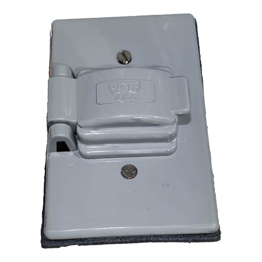 A gray plastic heavy-duty outlet cover with a hinged latch and a dark gray textured foam or rubber backing, featuring the embossed Eagle U.S.