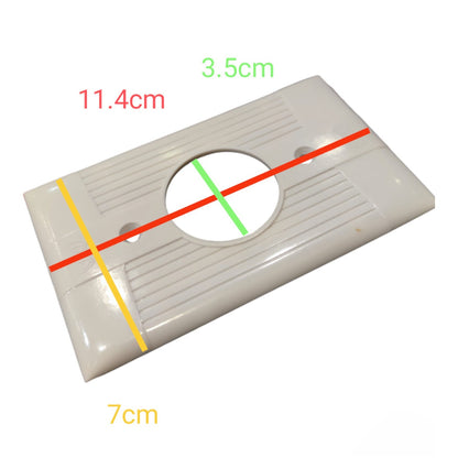 A white plastic rectangular wall plate or outlet cover with a circular cutout, overlaid with red, green, yellow, and orange measurement lines and text labels showing dimensions 11.4cm, 3.