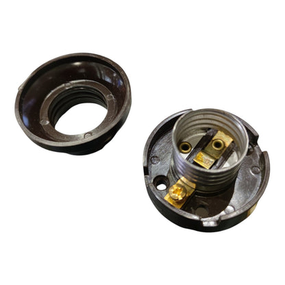 A disassembled metal electrical connector or socket component shown on a plain white background, with a dark outer ring and a threaded metal body revealing brass-colored internal contacts.