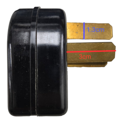 A black cylindrical plug or adapter with two brass-colored metal prongs, shown on a white background with red and blue dimension lines indicating 3 cm and 1.3 cm.