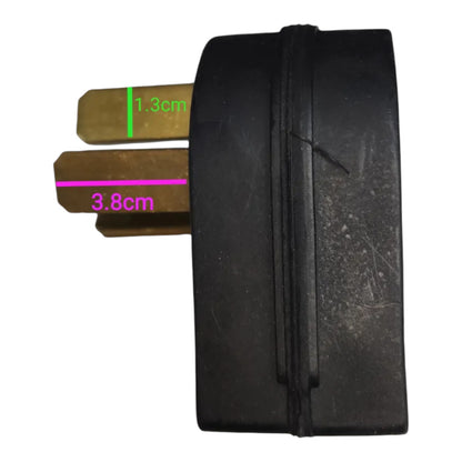 A black rubber or plastic cylindrical component with two brass metal tabs, overlaid with green and pink dimension lines showing measurements of 1.3cm and 3.