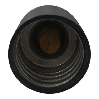 A close-up view of a black plastic threaded cap or connector showing the inner threaded opening and a small stamped marking inside.