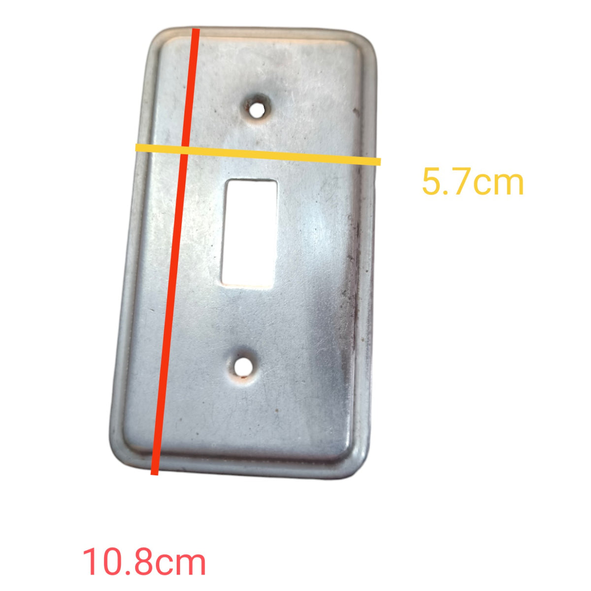 A rectangular metal light switch plate shown on a white background with overlaid dimension lines and text indicating 10.8 cm height and 5.