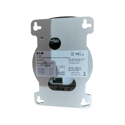 A B&T-N electronic optical smoke detector with a silver metal mounting plate, featuring a white label with technical specifications and a small digital display window.